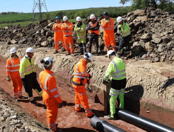 Workers lay underground power cables